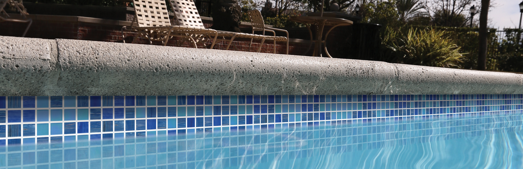 blue mosaic waterline tile with concrete coping