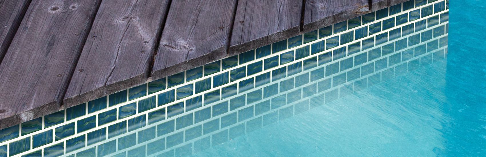 green glass tile waterline beside a wood deck